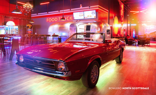 Red car inside a bowling alley