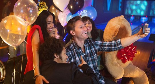 Friends taking a selfie at a birthday party