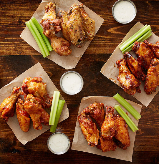 Wings in different sauces on tabletop